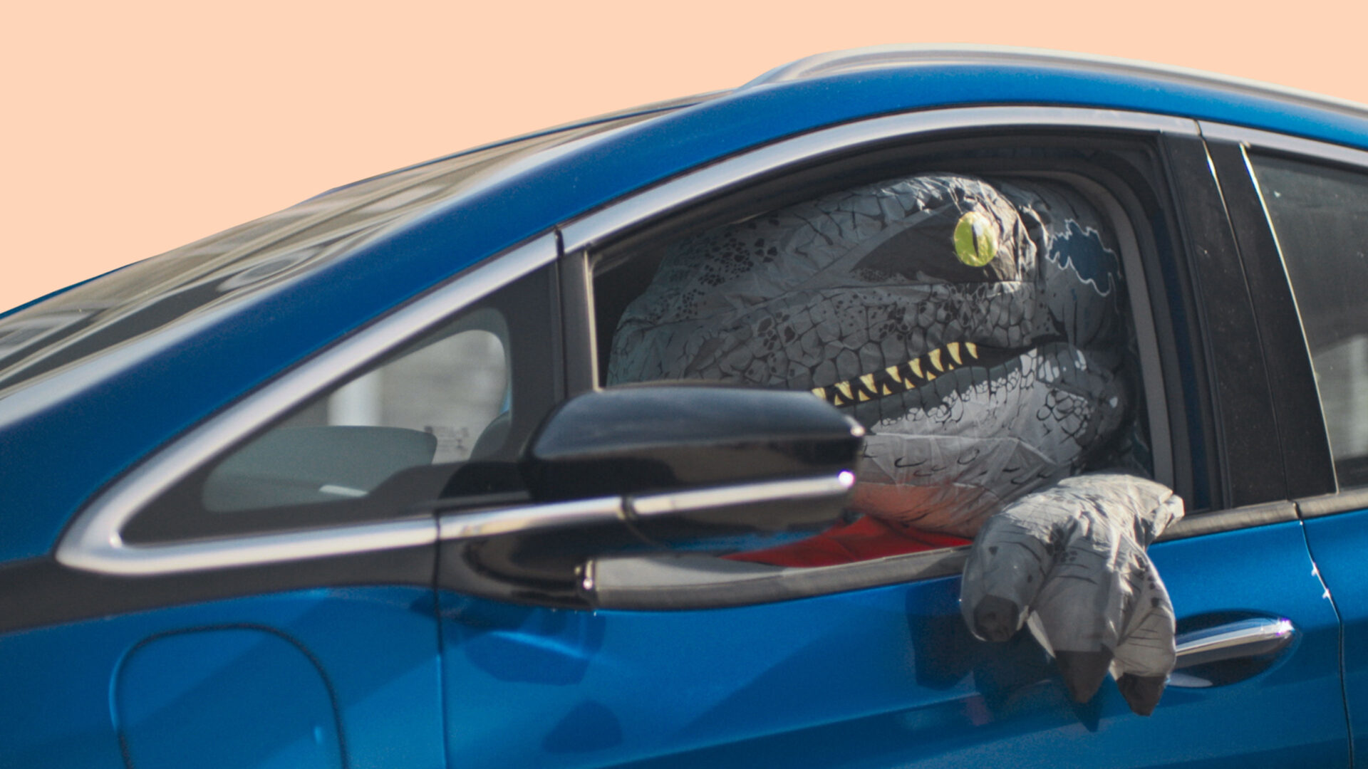 Dinosaur riding in a Chevy Bolt