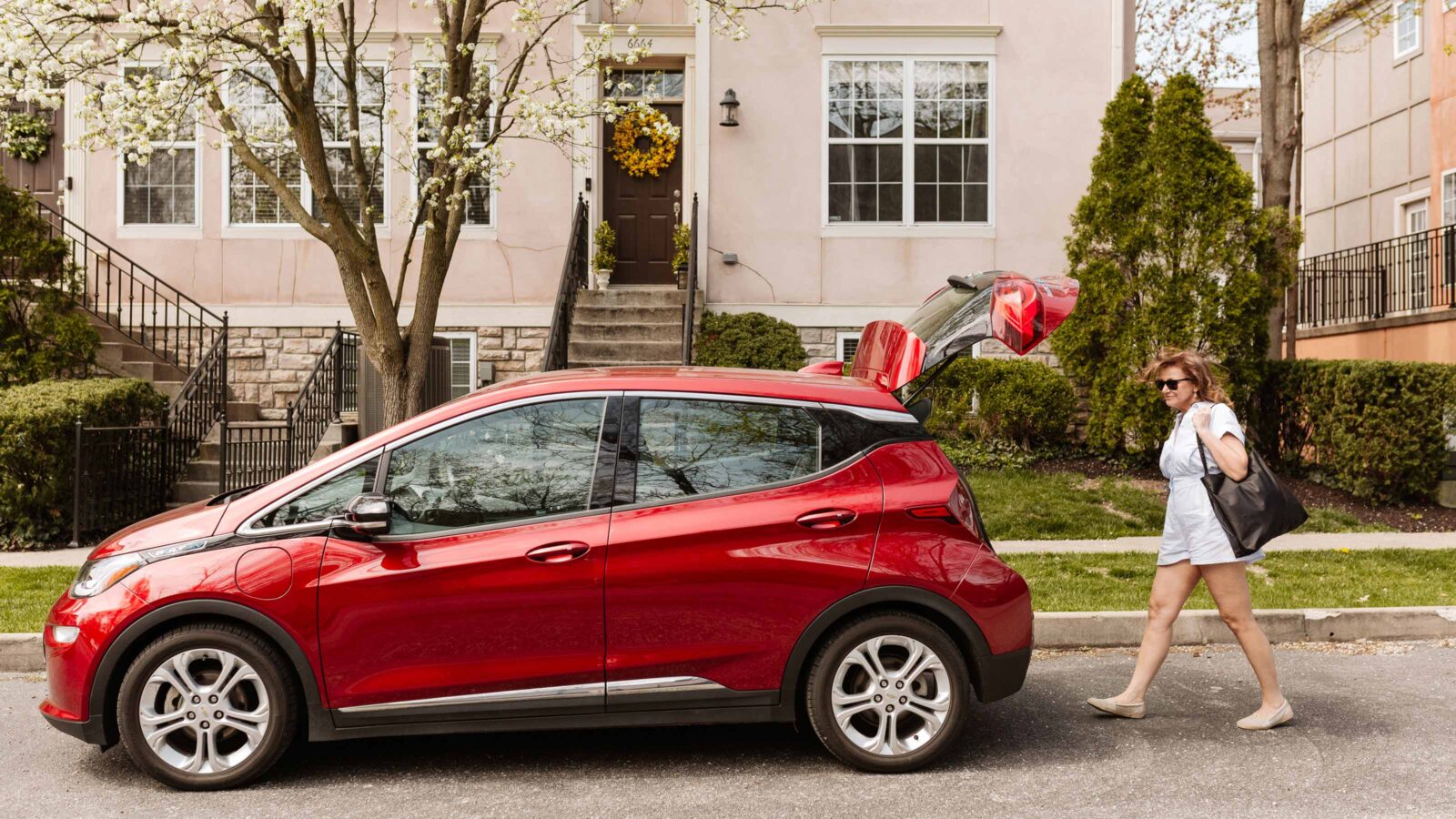 photo of woman with electric vehicle