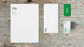 parks alliance business system including letterhead, envelop, and business card on a wooden background