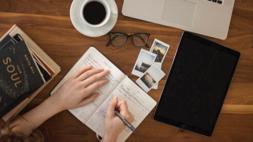 person writing on desk