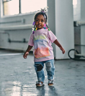 a young girl wearing a butter t-shirt