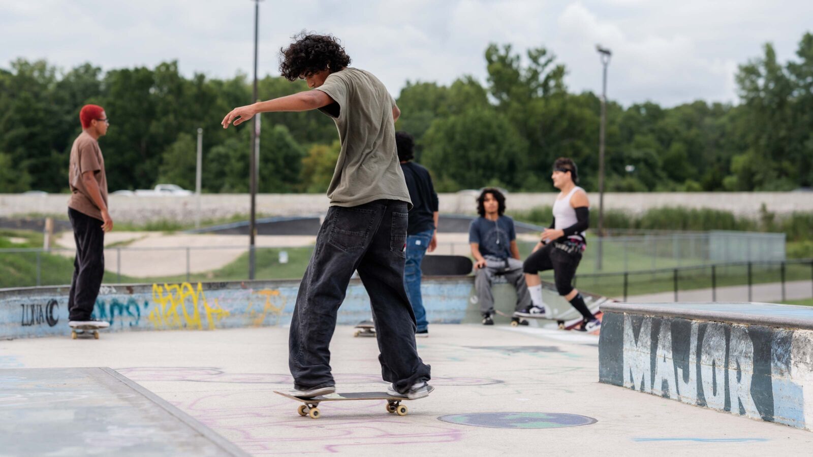 people skateboarding at a skate park
